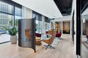 A living room with a large window and a wooden divider